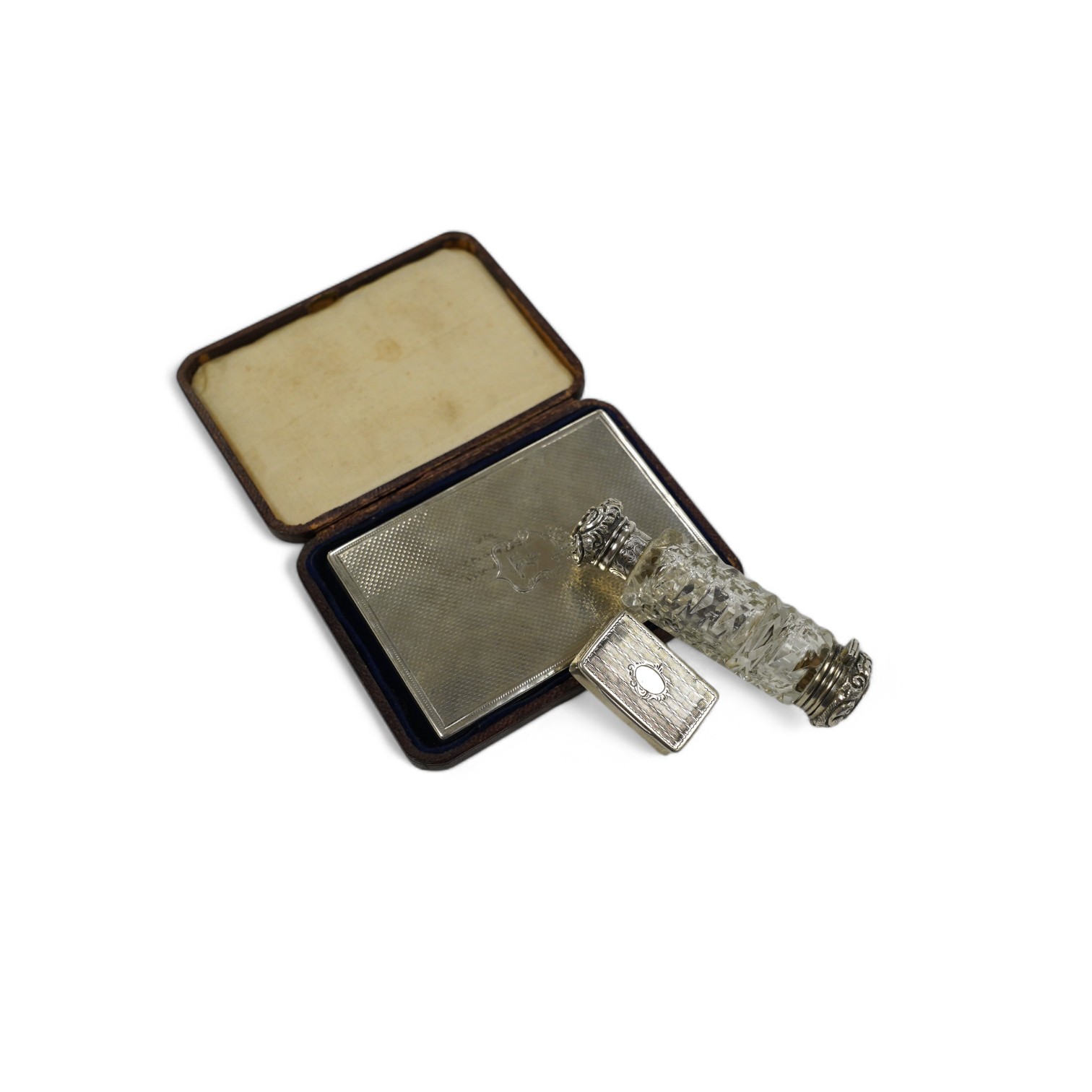 A Victorian silver mounted card purse, by Frederick Marson, Birmingham, 1859, 97mm, in a fitted case, together with a white metal vinaigrette and a white metal mounted cut glass double ended scent bottle, one end with a